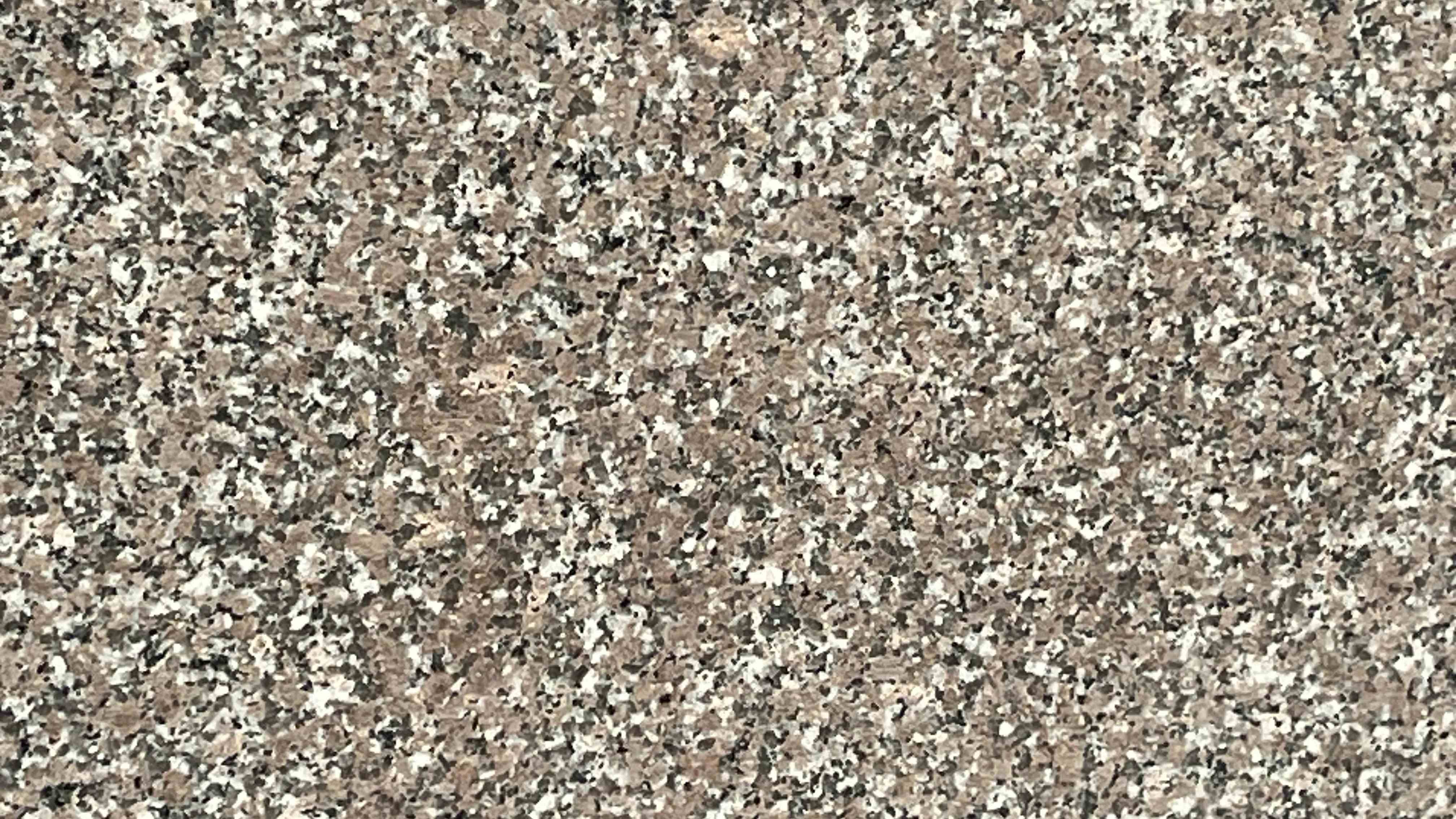 Premium Chima Indian Granite featuring a gentle, sophisticated pink and grey palette with a consistent calming pattern. High-quality polished slab supplied wholesale in Kishangarh.